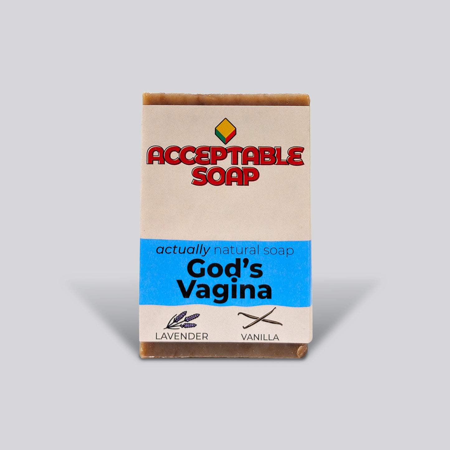Handmade natural bar soap labeled "God's Vagina" by Acceptable Soap, featuring lavender and vanilla scents with a minimalist paper wrapper.