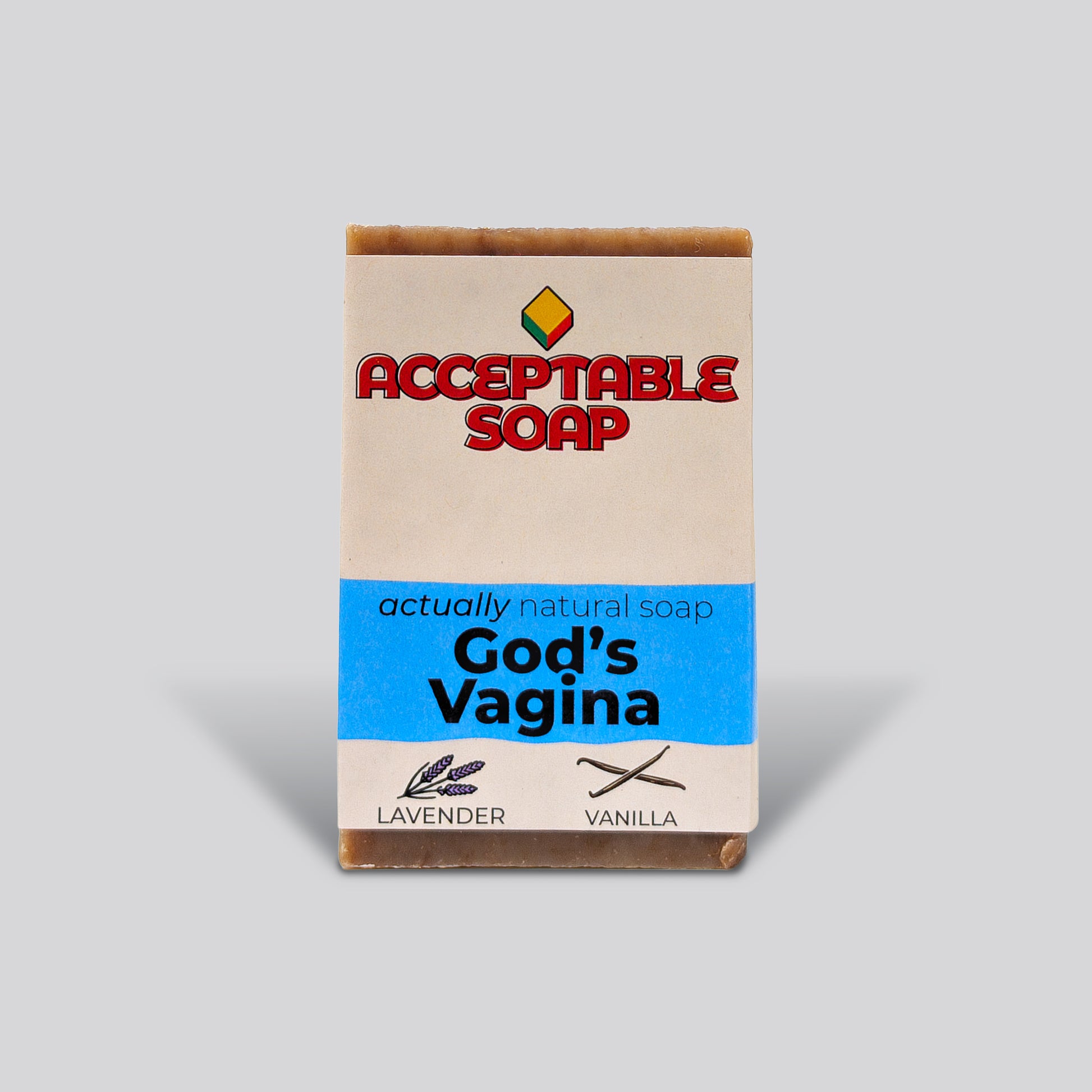Handmade natural bar soap labeled "God's Vagina" by Acceptable Soap, featuring lavender and vanilla scents with a minimalist paper wrapper.